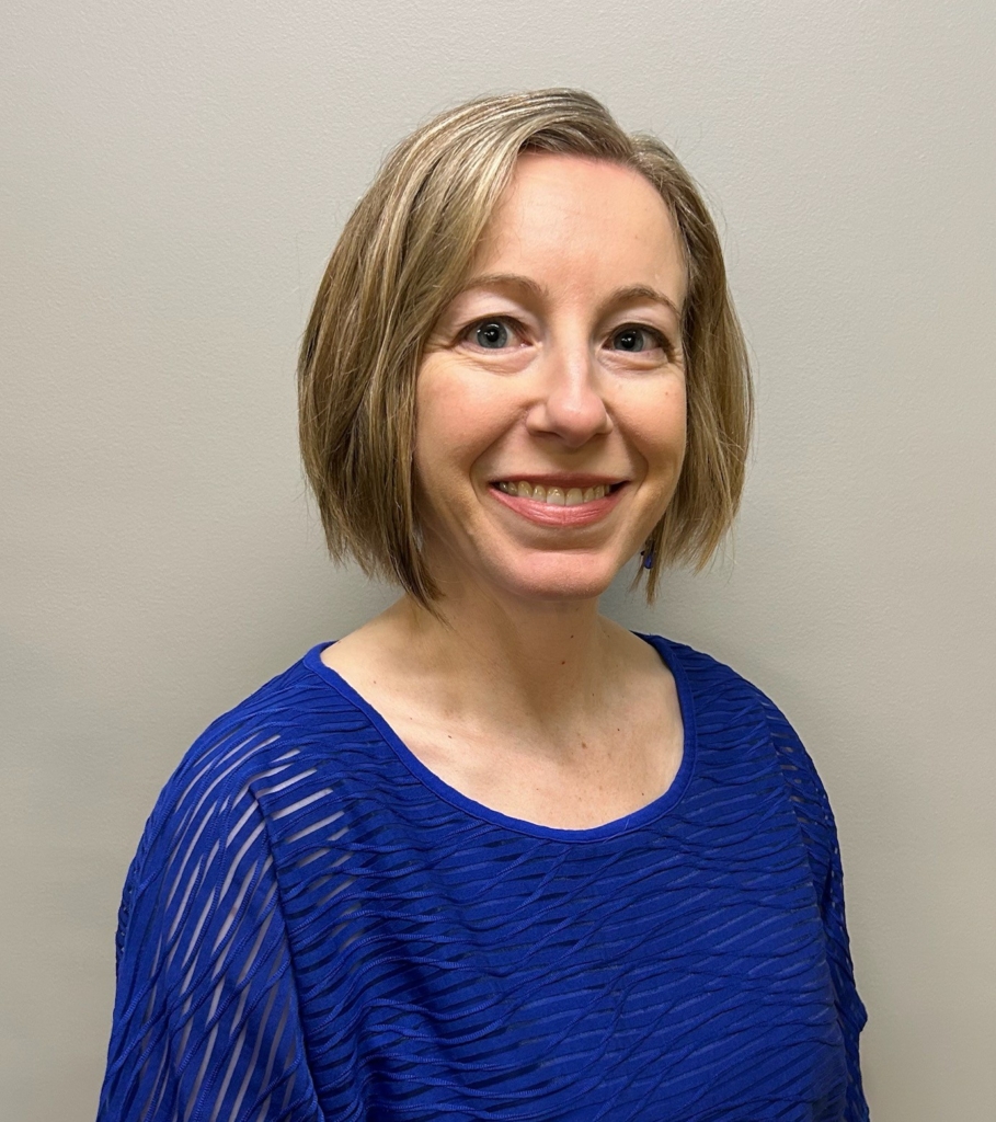 Headshot including shoulders and head of Dr. Stephanie Stoke, a physician who treats memory loss, smiling and wearing a blue sweater.