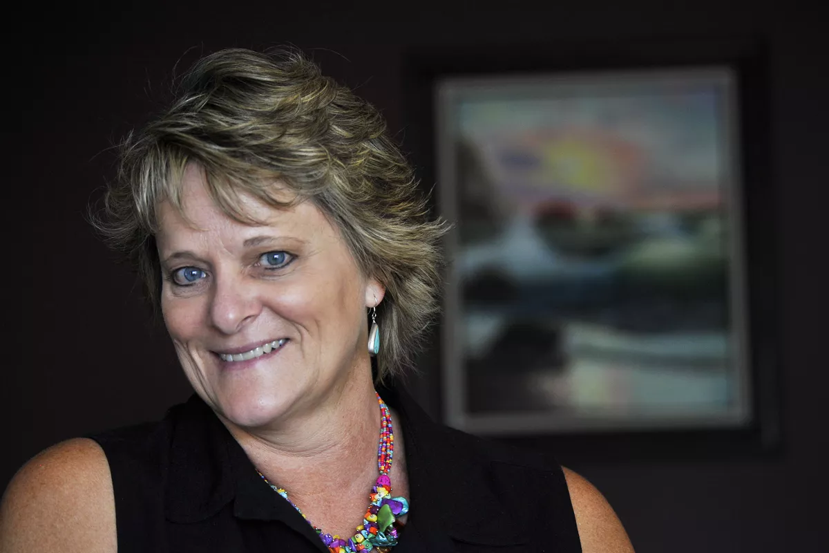 Headshot including shoulders and head of Becky Tiller, a licensed mental health counselor, smiling and wearing a black shirt..